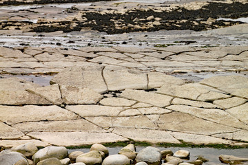 Kilve beach near East Quantoxhead in Somerset, England. Strata of rock dating back to the Jurassic era form huge cracked plateaux along the beach. The area is a paradise for fossil hunters