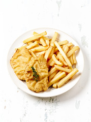 Pork Schnitzel with french fries on bright wooden background. Copy space. 