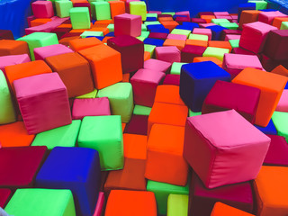 Soft cubes in the dry pool of the game children's room for kids.