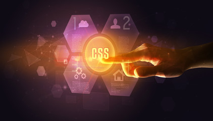 Hand touching CSS inscription, new technology concept