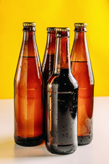 Bottles of beer in different colors. Light and dark beer. Beer background for advertising, chilled...