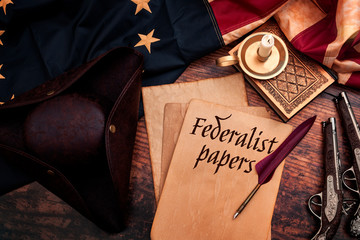 Federalist papers and the birth of the United States of America concept with tricorn hat, candle,...
