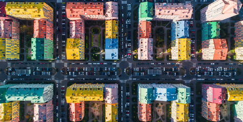 Urban landscape of colorful buildings. Aerial view of the colorful buildings in the European city in the morning sunlight. Cityscape with multicolored houses, cars on the street in Kiev, Ukraine.