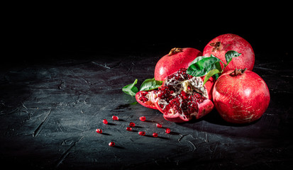 Sweet, ripe and fresh garnet on dark background. Juicy heap of pomegranate seeds
