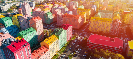 Urban landscape of colorful buildings. Aerial view of the colorful buildings in the European city in the morning sunlight. Cityscape with multicolored houses, cars on the street in Kiev, Ukraine.