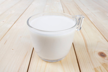 Almond milk glass isolated on wooden table