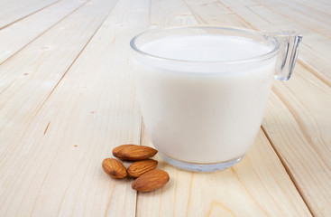 Almond milk glass isolated on wooden table