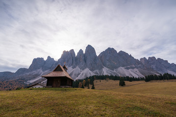 Scenery with small church in alps dolomites in Italy South Tyrol with Sass de Putia mountain on background