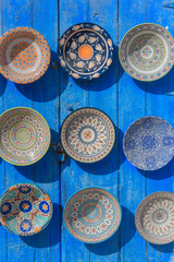 Traditional ceramic Oriental kitchenware on the wall of the Bazaar of Morocco.