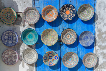 Fototapeta na wymiar Traditional ceramic Oriental kitchenware on the wall of the Bazaar of Morocco.