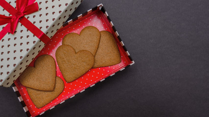Heart-shaped cookies in a gift box on a black background