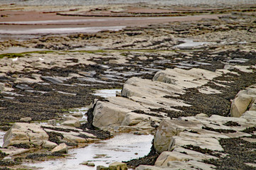 Rocks on Kilve beach near East Quantoxhead in Somerset, England. Stratified layers of rock date back to the Jurassic era and are a paradise for fossil hunters.