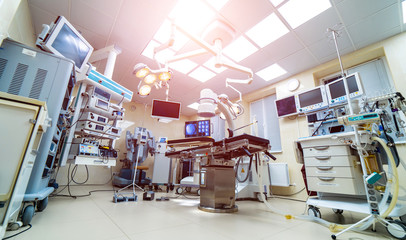 Clinic interior with operating surgery table, lamps and ultra modern devices, technology, hi-tech...