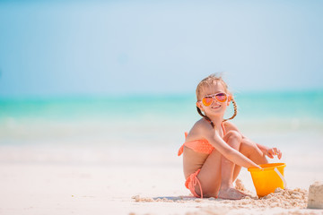 Adorable little girl at beach during summer vacation