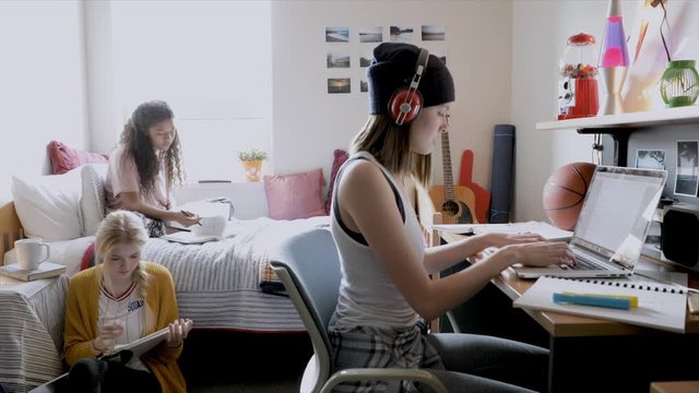 Female College Students Studying In Dorm Room