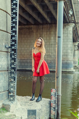 A woman is posing in front of a camera in an autumn park. autumn photo shoot. Autumn in the park.