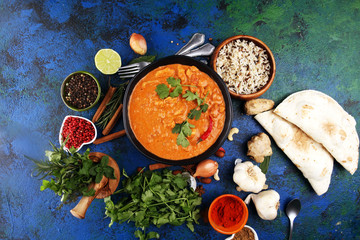 Chicken tikka masala spicy curry meat food in pot with rice and naan bread. indian food