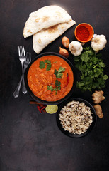 Chicken tikka masala spicy curry meat food in pot with rice and naan bread. indian food