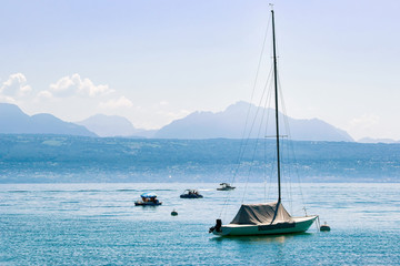 Motorboat on Lake Geneva in Lausanne, Switzerland. Alps on the background