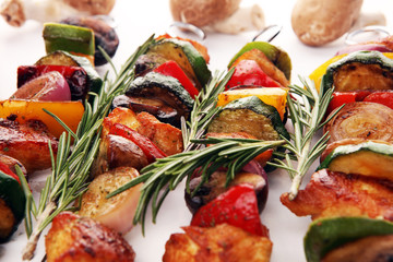 Grilled pork shish or kebab on skewers with vegetables . Food background shashlik