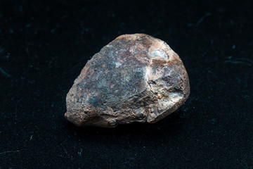 Fototapeta premium Chondrite Meteorite L6W2 Type isolated, piece of rock formed as an asteroid in the universe at during Solar System creation. The meteorite comes from an asteroid fall impacting Earth at Atacama Desert