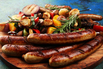 Assorted delicious grilled meat with vegetable on a barbecue with Grilled pork shish or kebab on skewers with vegetables.