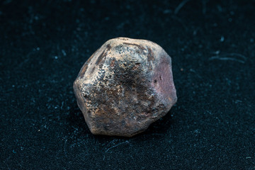 Fototapeta premium Chondrite Meteorite L6W2 Type isolated, piece of rock formed as an asteroid in the universe at during Solar System creation. The meteorite comes from an asteroid fall impacting Earth at Atacama Desert