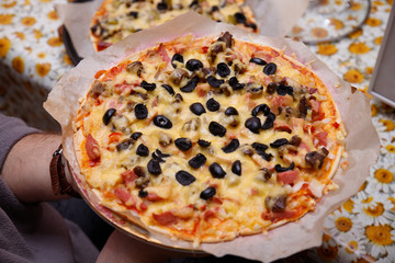 Overhead shot of friends at a table sharing take-away pizzas