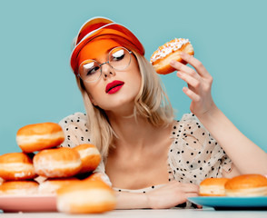 Beautiful woman in 90s clothes with donuts