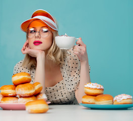 Beautiful woman in 90s clothes with donuts and coffee