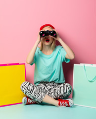 Style woman with shopping bags and binoculars