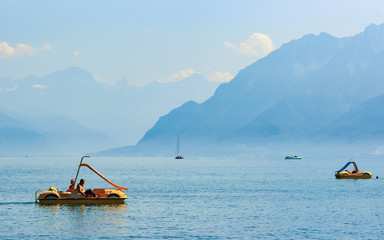 Lausanne, Switzerland - August 26, 2016: People in catamarans at Geneva Lake in Lausanne,...