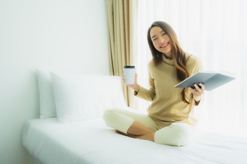 Young asian woman with coffee cup and read book