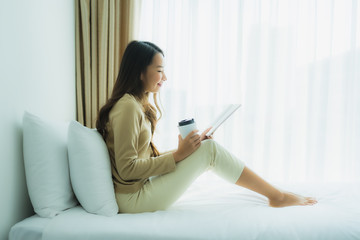 Young asian woman with coffee cup and read book