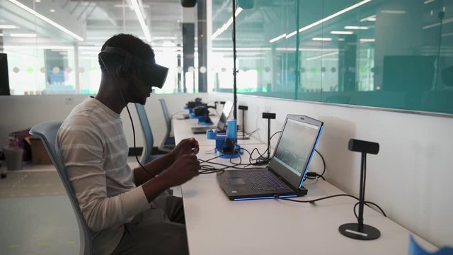 Student Putting On VR Headset In Classroom