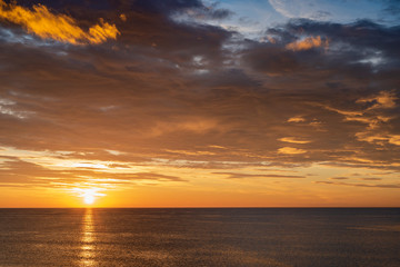 Early sunrise and epic cloudy sky above the sea. Coast of Torrevieja, Alicante, Spain. Mediterranean sea 2019