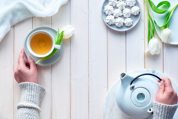 Spring decorations on white wooden boards, text 