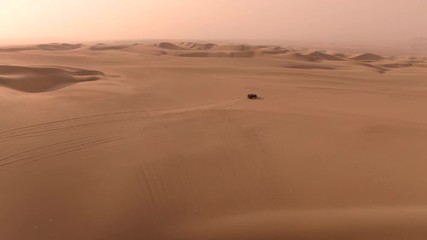Sandy desert oasis lake. DRONE. Water in middle of hot sand desert. Romantic, holiday, honeymoon, scenic shot, with sand ripples and footprints. Tourism shot in Huacachina, Peru. Epic, dramatic shot.  - Powered by Adobe