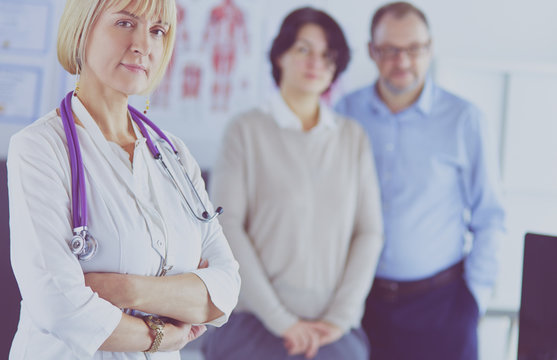 Smiling Medical Doctor With Stethoscope And Elderly Couple