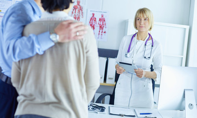 Medical doctor and young couple patients in hospital