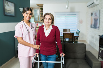 Confident Caregiver With Disabled Patient At Home