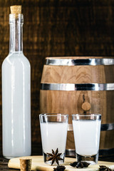 Arabic alcohol drink Raki with anis on wooden background.Turkish and Greek Traditional aperitif arak, Ouzo. Distilled drink with anise base, space for text.