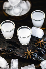 Traditional arabic alcohol drinks Raki with anise, rustic wooden background with space for text.