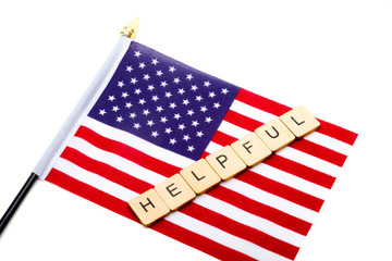 Fototapeta premium The flag of the United States isolated on a white background with a sign reading Helpful