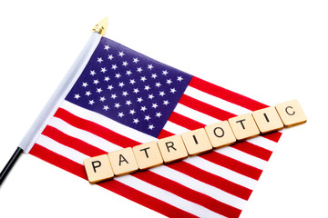 The flag of the United States isolated on a white background with a sign reading Patriotic