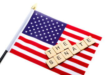 The flag of the United States isolated on a white background with a sign reading The Senate