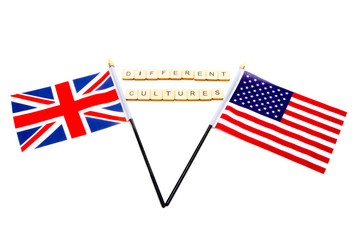 The flags of the United Kingdom and the United States isolated on a white background with a sign reading Different Cultures