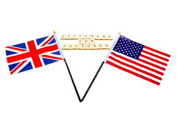 The flags of the United Kingdom and the United States isolated on a white background with a sign reading Different Gun Cultures