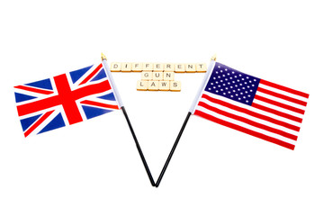 The flags of the United Kingdom and the United States isolated on a white background with a sign reading Different Gun Laws