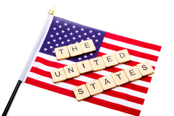 The flag of the United States isolated on a white background with a sign reading The United States